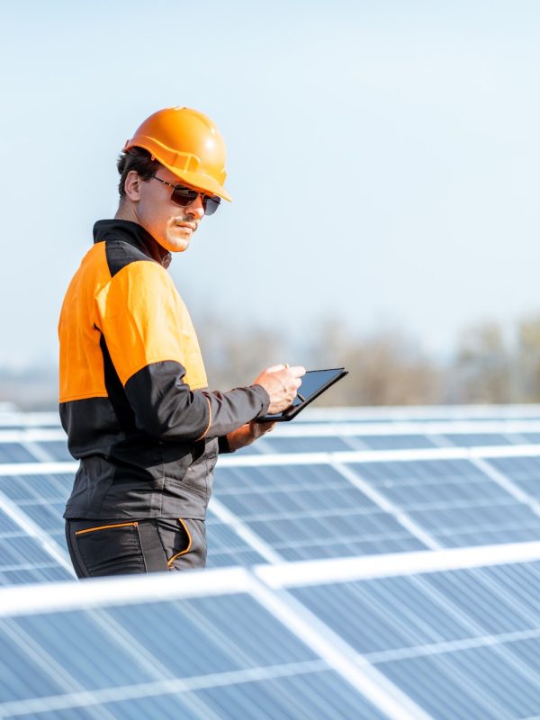 engineer-servicing-solar-panel-on-electric-plant.jpg